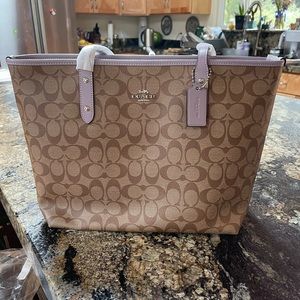 Cute leather signature city zip tote.